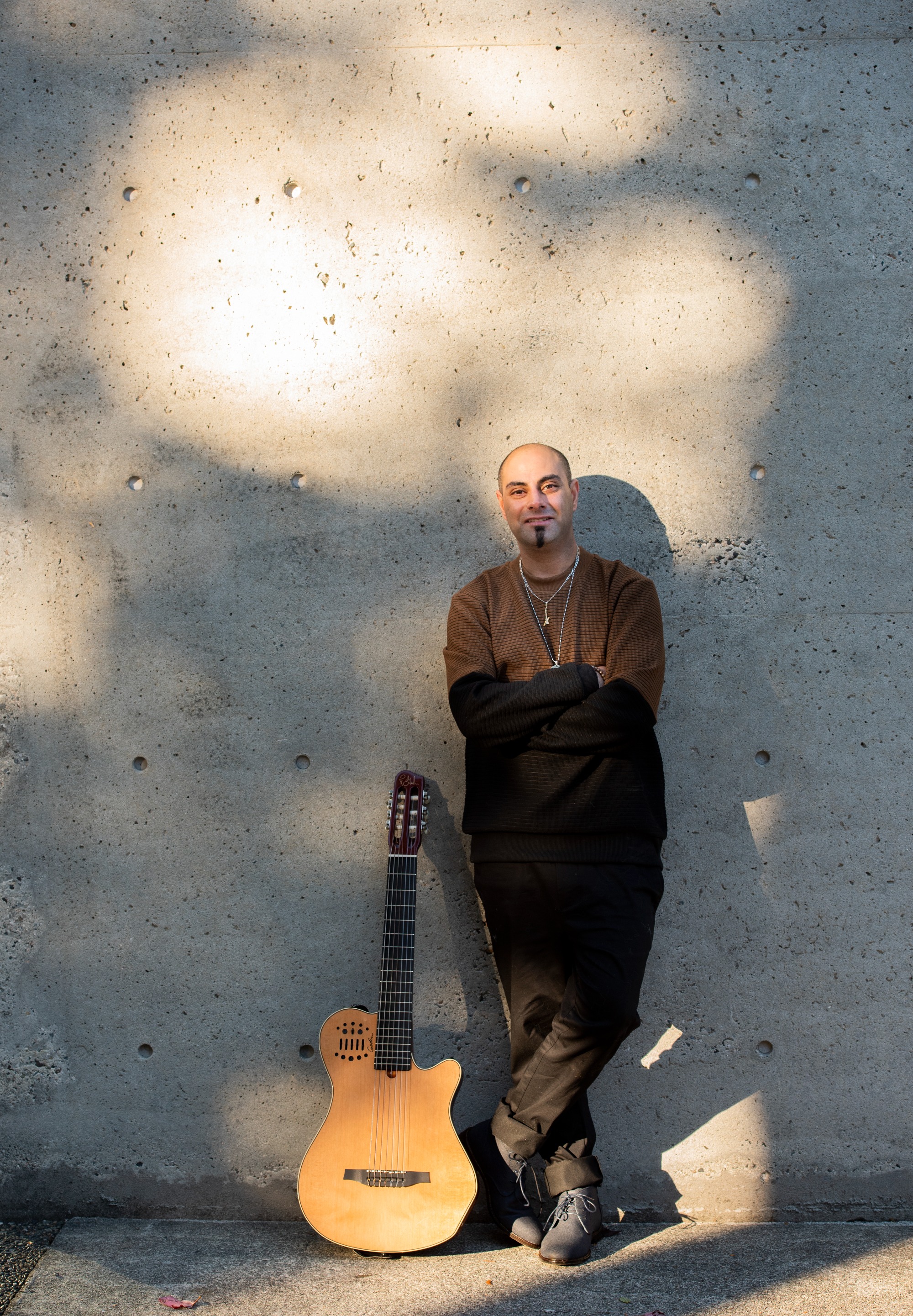Daniel Fotoohi, known as Bluebuddy, with his guitar
